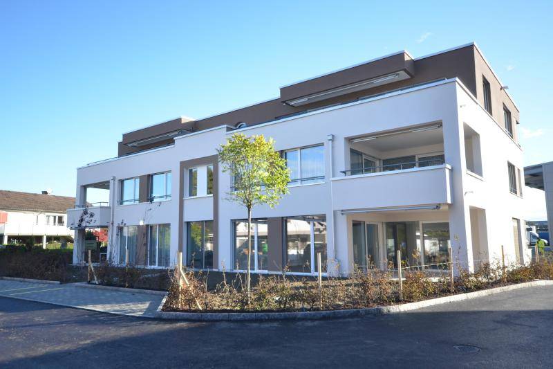 Die unteren zwei Geschosse sind in weiß verputzt. Das obere Geschoss ist in einem grau-braun gestrichen.